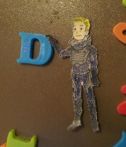 The David cut-out touches a plastic magnet D