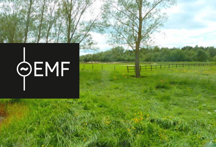 EMF Camp logo and a photo of the field